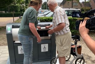 Wethouder en inwoner doen container dicht